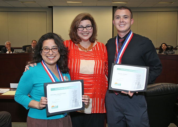 Board of Trustee Clerk Arianna P. Barrios (center) presents Darliene Zepeda (left) and Dylan Sickler with certificates