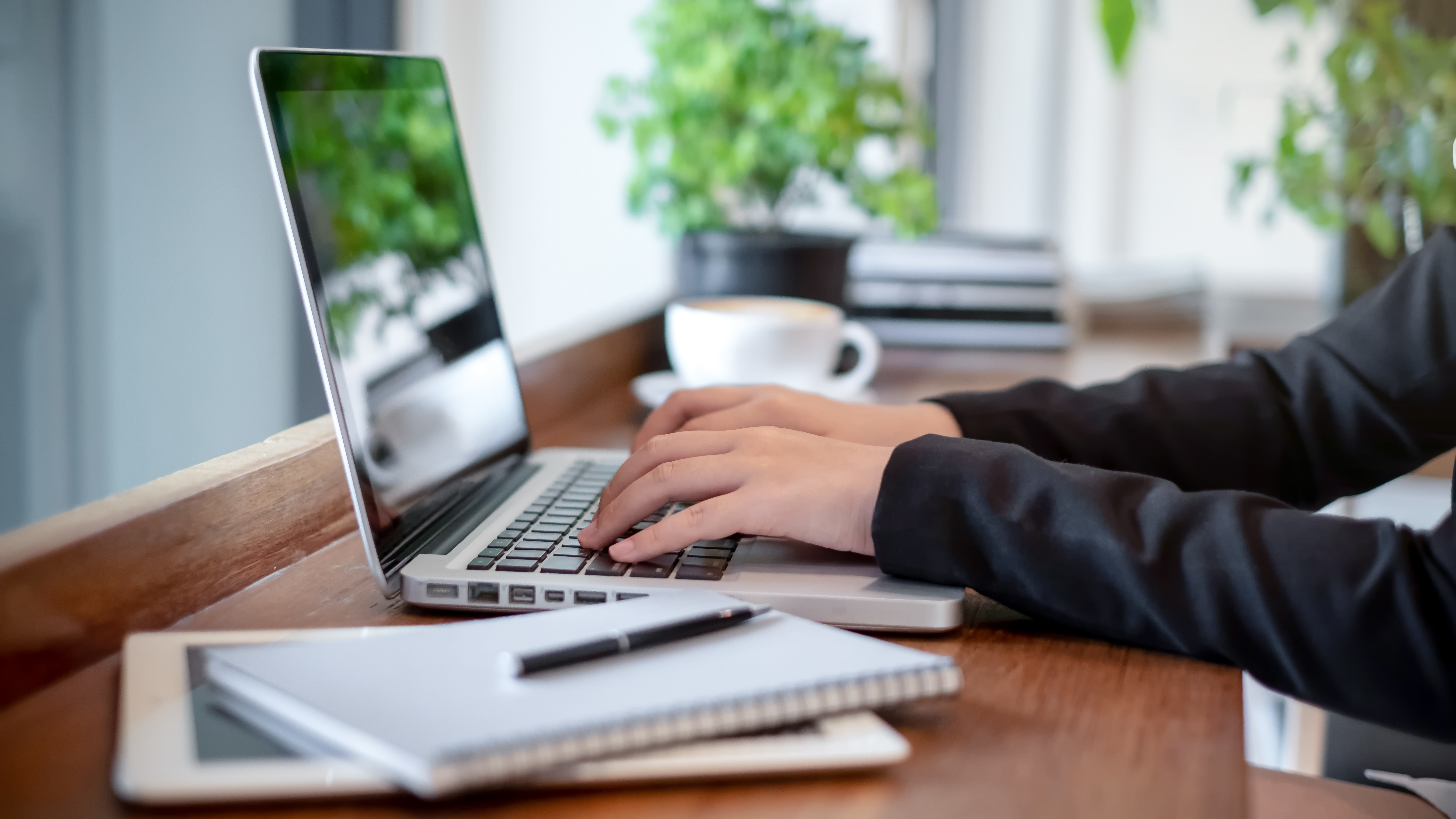 close up of a person hands typing on a laptop